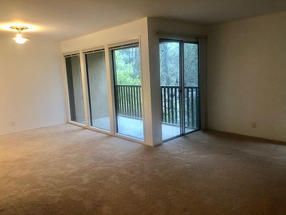 living room / dining area with wall of windows