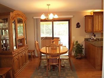 Large dining area open to the kitchen and a sliding glass door accessing the screened porch.