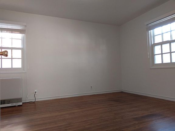 bedroom with newer gas wall heater