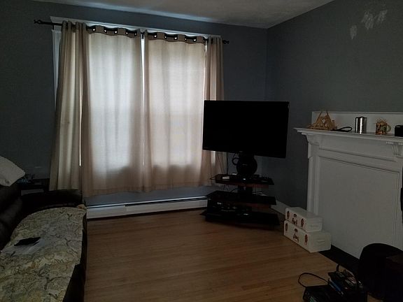 Newly painted living area with faux fireplace