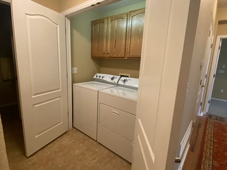 Laundry room across from coat closet in alcove