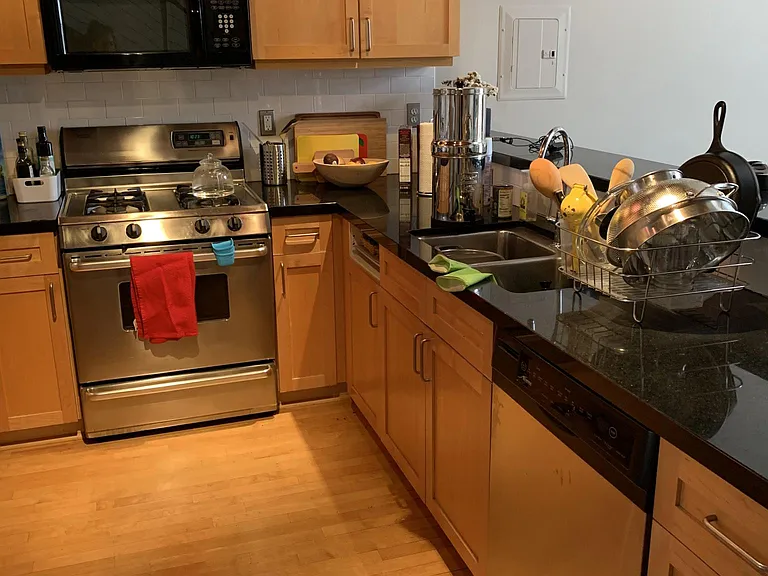 Large kitchen with lots of counter space and storage space with cabinets, drawers and extra space in the corner spcaces for pots and pans