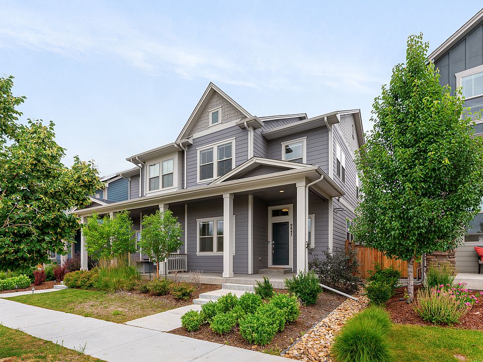 Charming two-story gray house with a spacious covered front porch and well-maintained garden. Surrounded by greenery and trees, this cozy home offers a welcoming atmosphere perfect for a relaxing stay in a peaceful neighborhood.