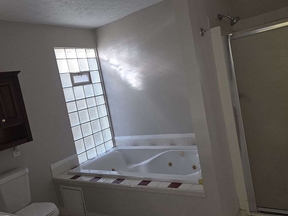 Jacuzzi tub & stan c up shower.