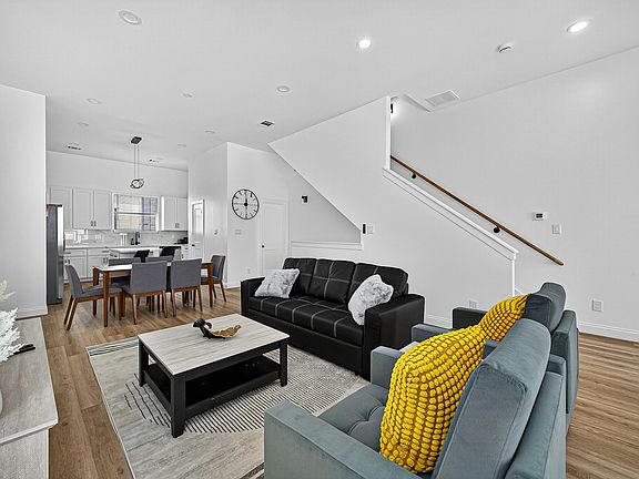 Open Concept Seamless living/dining area with hardwood floors and neutral palette.