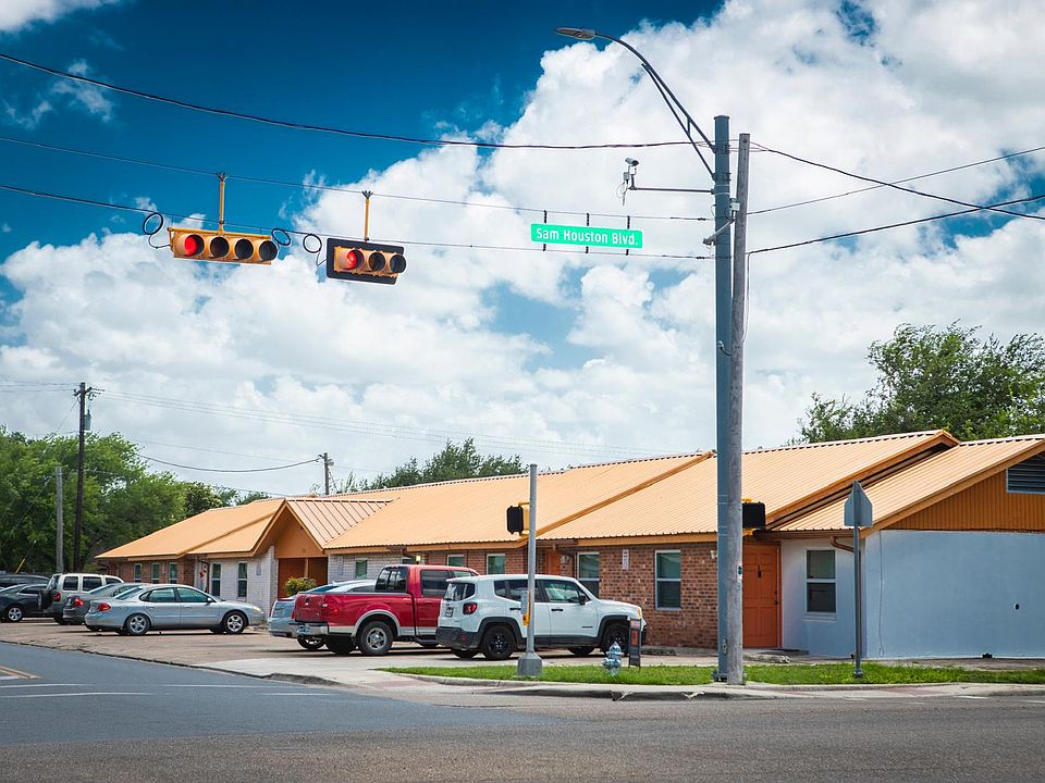 "Exterior view of the property with convenient street access and ample parking. The building features a clean, well-maintained facade and is located near major roads, offering easy access to shops, dining, and public transportation.