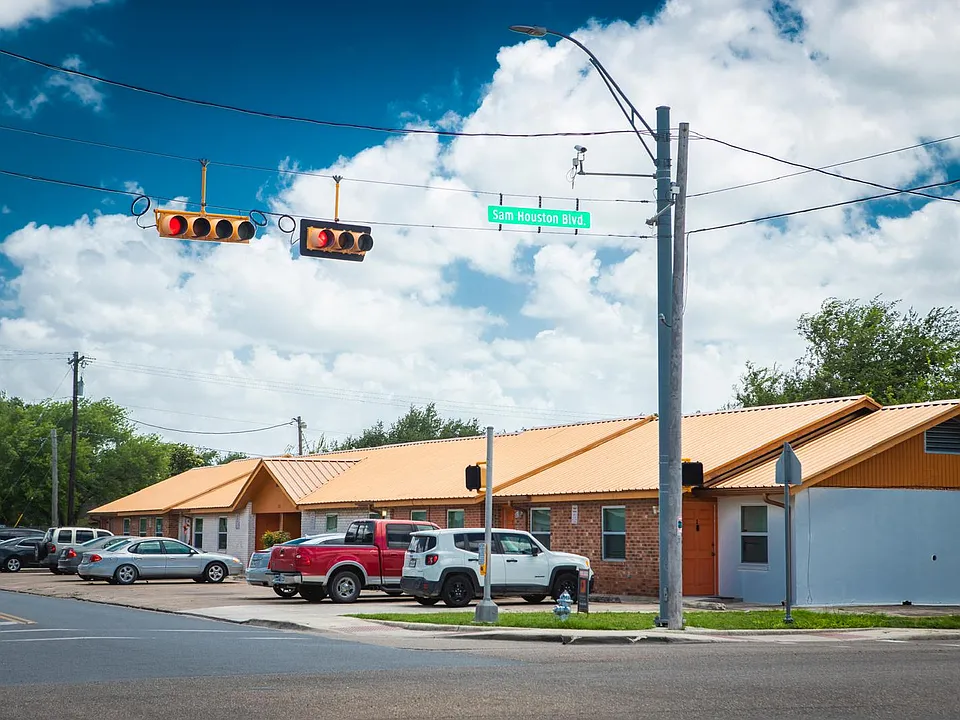 "Exterior view of the property with convenient street access and ample parking. The building features a clean, well-maintained facade and is located near major roads, offering easy access to shops, dining, and public transportation.