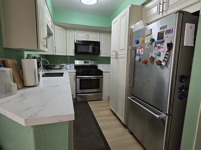 Newly remodeled kitchen, washer and dyer are inside the tall cabinet.