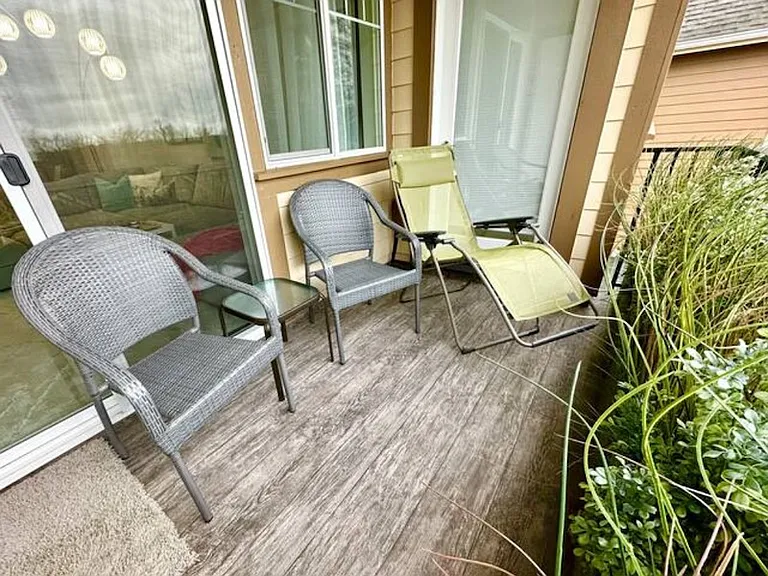 Covered balcony seating area (living room + primary suite access)