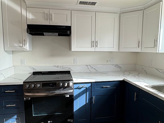 Brand new kitchen cabinets, counters, and appliances.