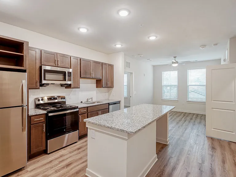 Unit Kitchen with Living Room in the Background