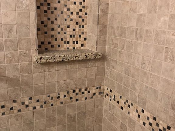 Newly tiled shower in main bathroom