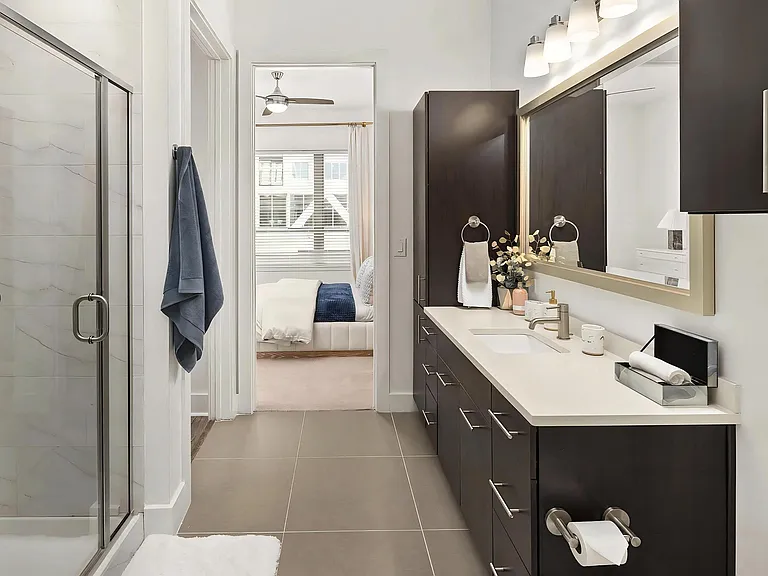 Ensuite Bathroom with Modern Cabinetry, Lighting, and Ample Counter Space