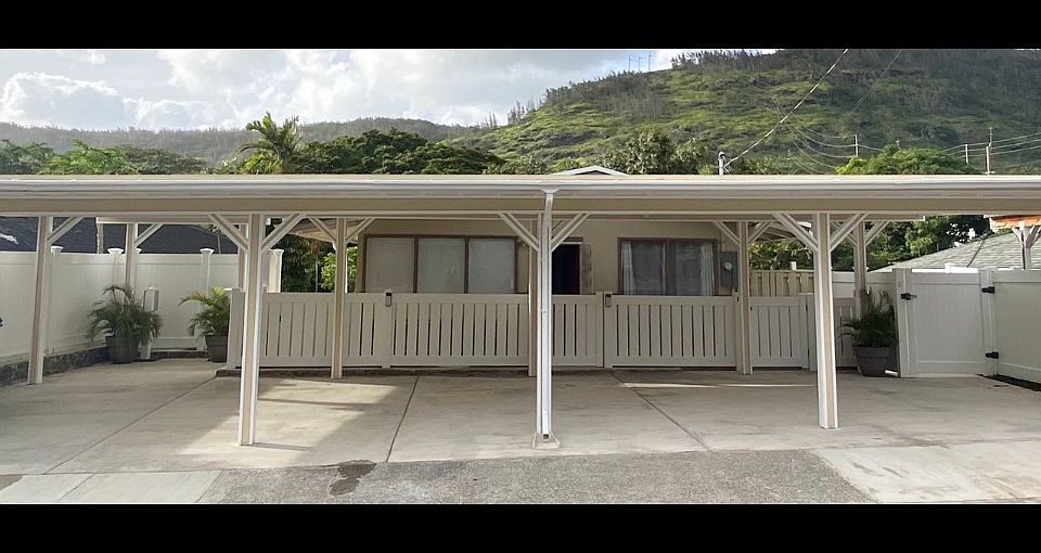 Front of home with large carport - spots available on each end (2 spots) 
Middle spots flare for the owners