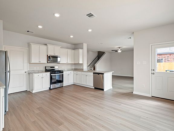 A dining room and adjoining kitchen
