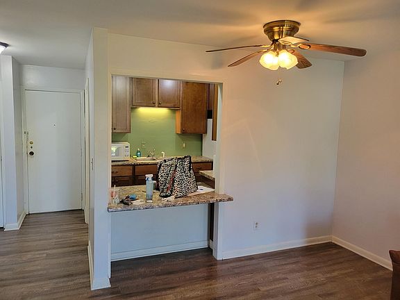 Living room facing entry & kitchen