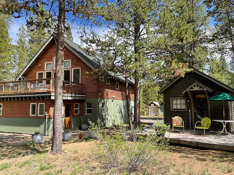 Creekside upstairs deck. Below is the downstairs unit's entrance. The little cabin is for the downstairs tenant's use.