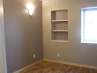 Bedroom with built in bookshelf, deep window sill.