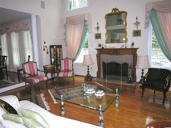 Majestic 2 story great room w/fireplace, hardwoods, and wall of windows.