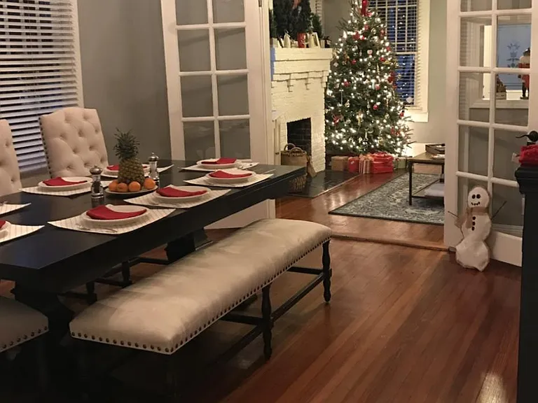 Large dining room with original French doors and hardwood floors