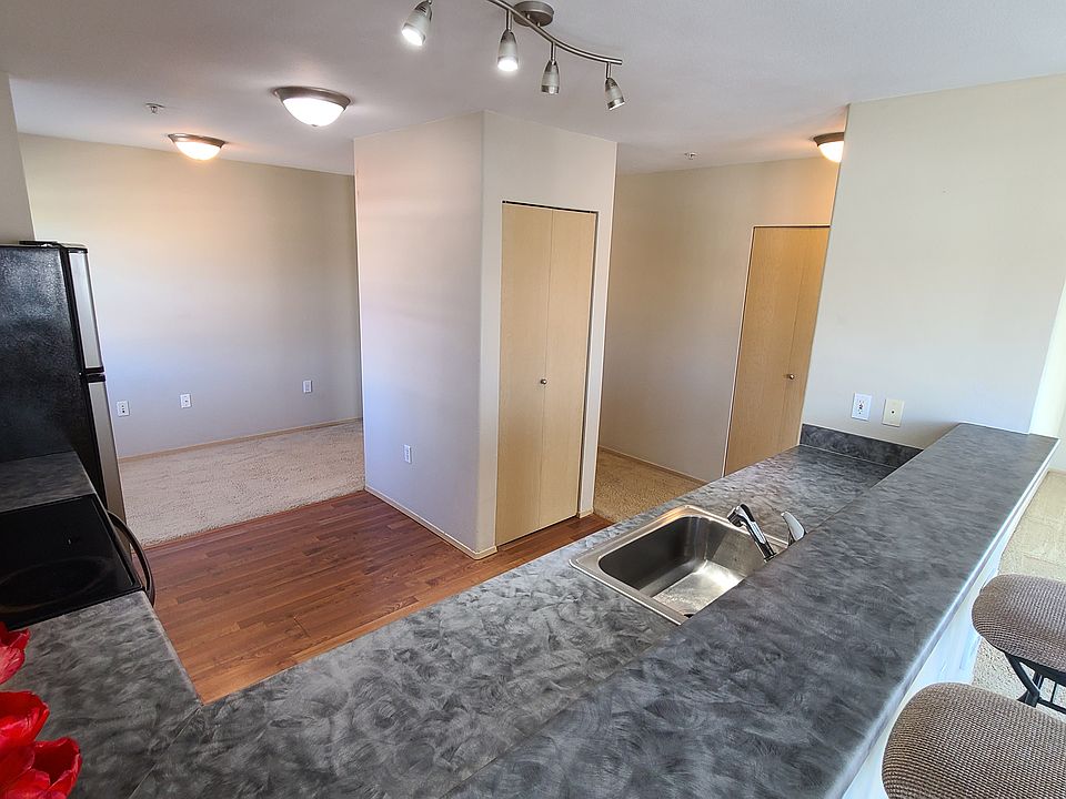 The view sitting in one of the bar stools looking over the counter tops at the pantry and nice bonus area.