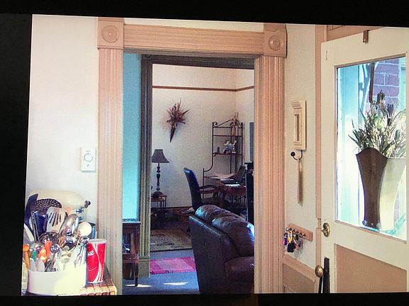 kitchen and view of front door and in background is door to living room and south bedroom