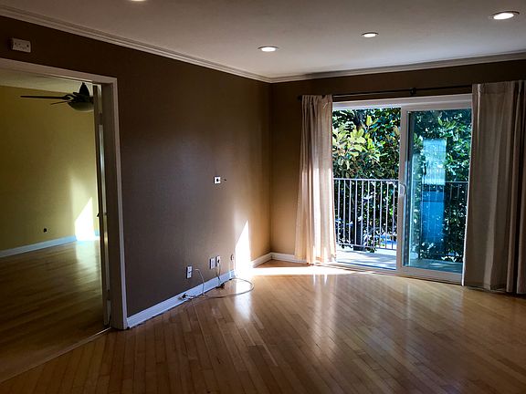 Living space with balcony facing Balboa Park.
