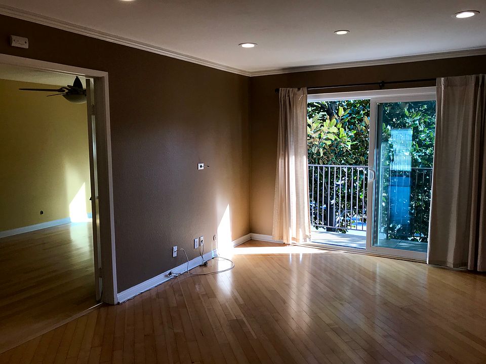 Living space with balcony facing Balboa Park.