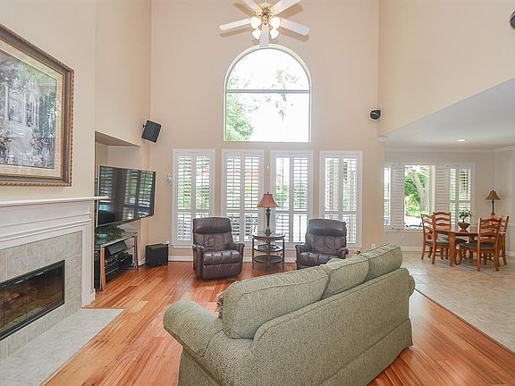 Two story family room with beautiful wall of windows overlooking the pool/spa and golf course. Plantation shutters are all the decor you need. Clean lines and much natural lighting