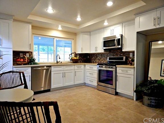 Kitchen features Quartz counters, under mounted sink, New Cabinets, New appliances, New flooring, Recessed lights, Nad designer details like Glass back splash.