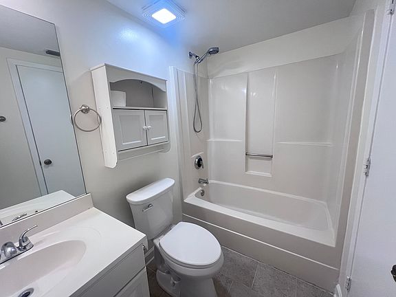 bathroom with new toilet and exhaust fan