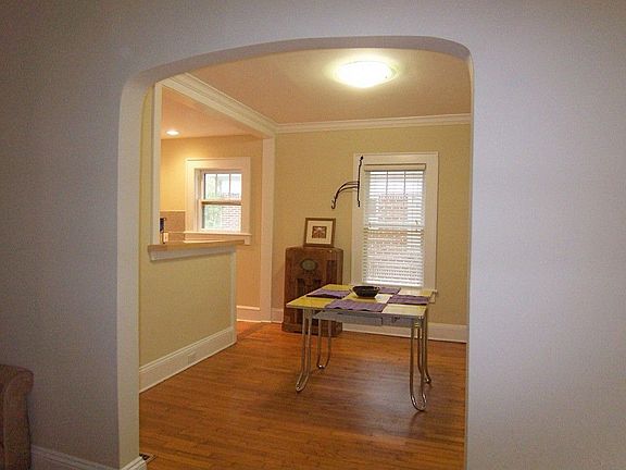 Charming archway leads to dining room and open kitchen