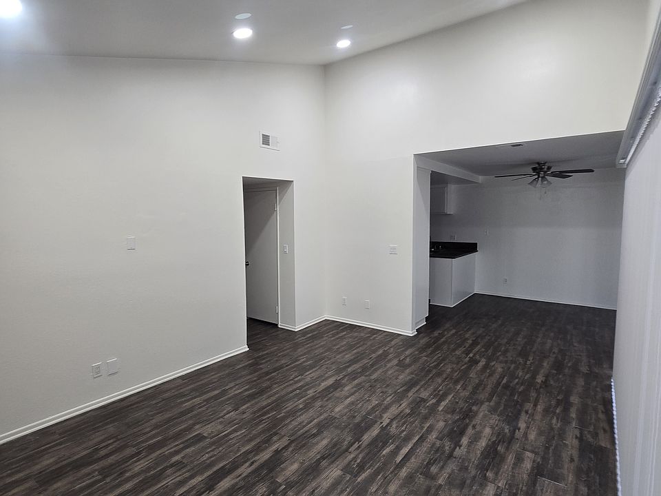 Living room view. Vaulted ceiling with brand new light fixtures.
