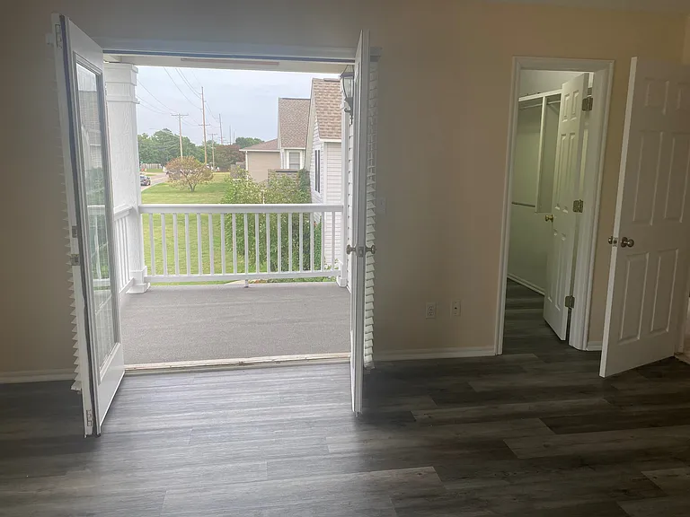 Balcony and closet in primary bedroom