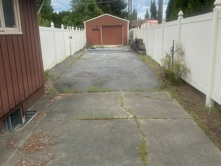 Long driveway for recreational vehicles & shop at back Has locking gate