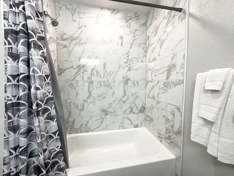 Sparkling clean bathtub/shower combo.