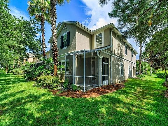 Rear view with two story condo featuring screened porch