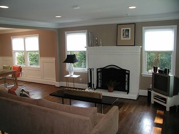 Living room has recessed lighting, picture and crown molding and fireplace