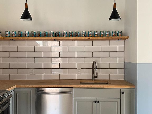 Kitchen with new appliances and open shelving
