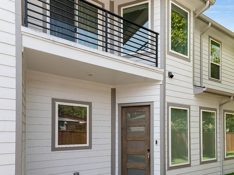 The front door is stylish and operates with a secure keyless entry. The balcony above the door is located off the dedicated workspace.