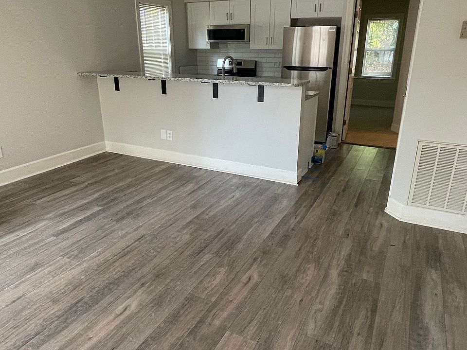 View from front door of living area looking toward bar and kitchen