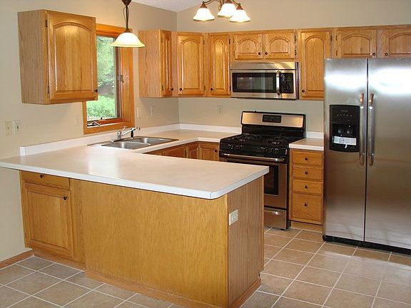 Kitchen has new tile floors, stainless appliances, and new lighting.