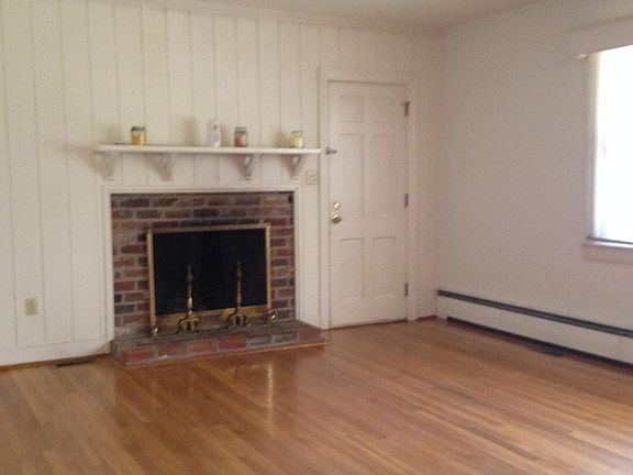 Living room showing fireplace and door to screened porch