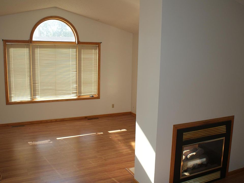 Living room w/ 2 sided fireplace. Vaulted ceiling.
