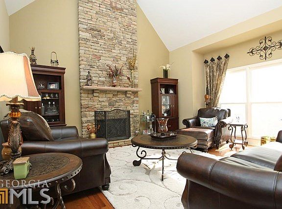 Fantastic great room with stacked stone fireplace soaring to cathedral ceilings