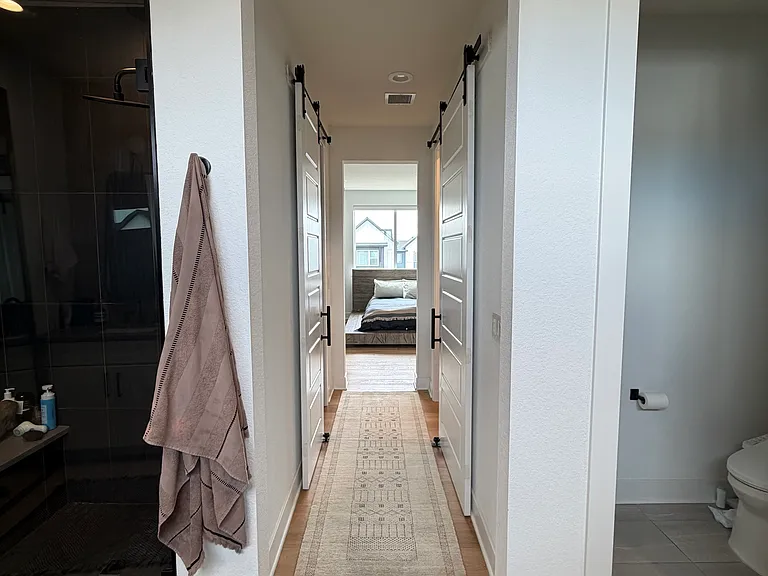 Primary bedroom hallway from bathroom