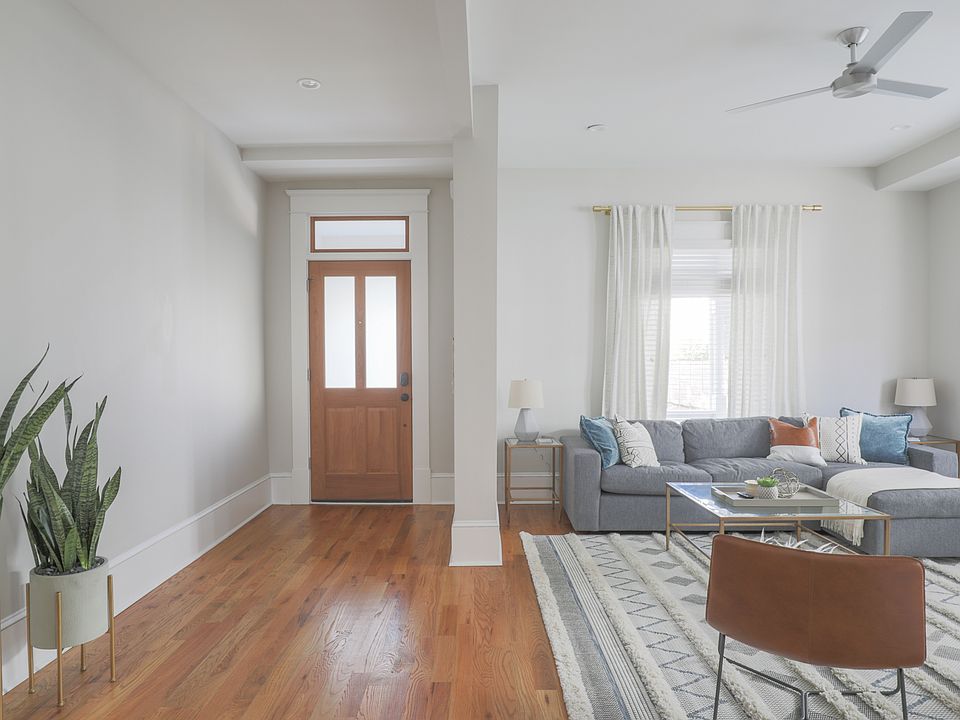 Foyer and Living Room (Photos shown with staging for layout reference _ unit offered unfurnished.)