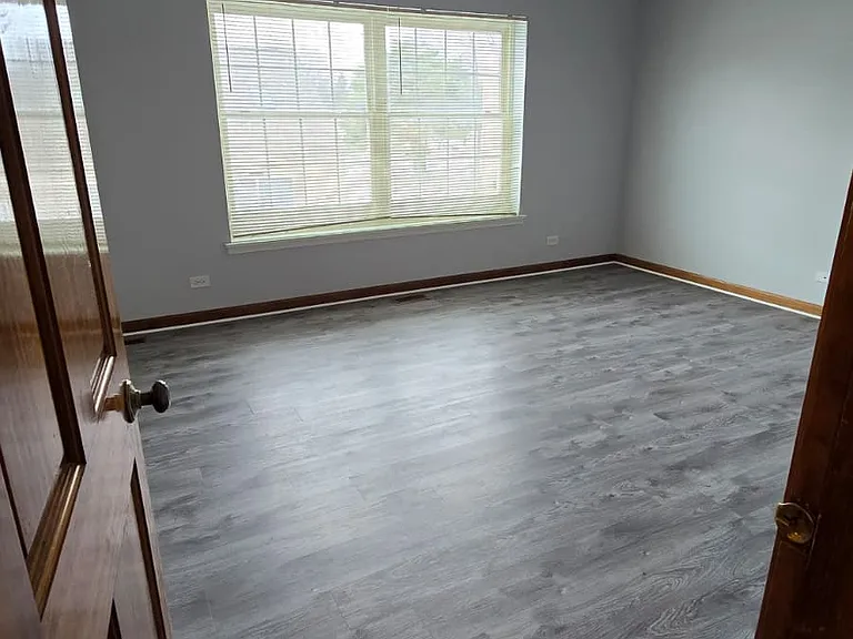 Main bedroom with two large windows and huge bathroom
