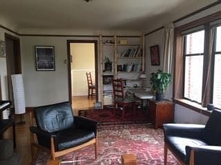 View from living room toward dining or desk area, breakfast nook and kitchen.