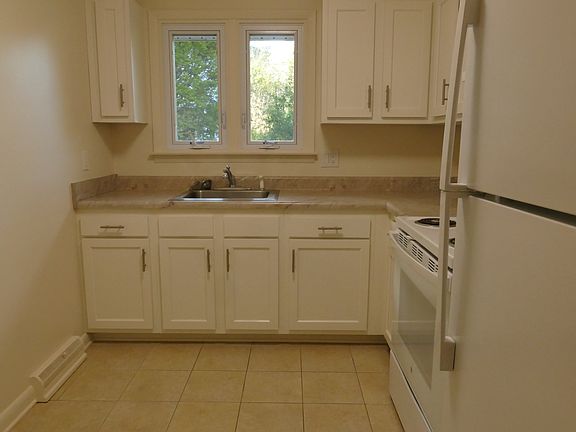 New cabinets, stove and refrigerator.